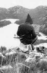 Franklin Charmichael sketching on his rock, Grace Lake 1935
